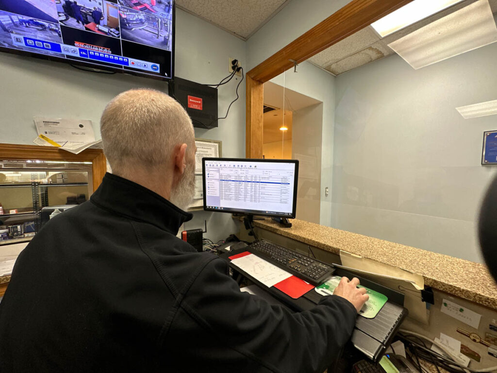 Employee Checking Spreadsheet at Ronnie's Automotive in Billerica, MA.